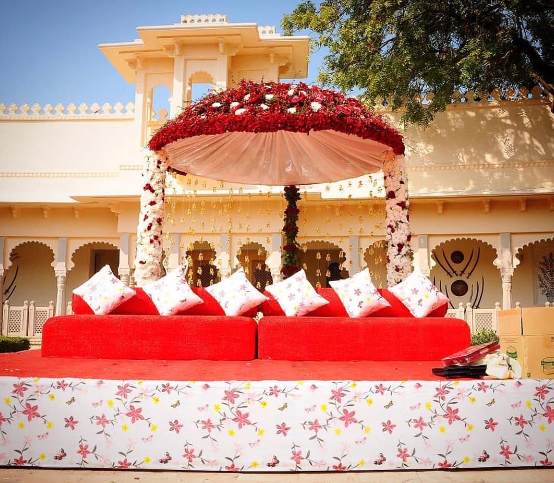 Red wedding mandap in a palace courtyard