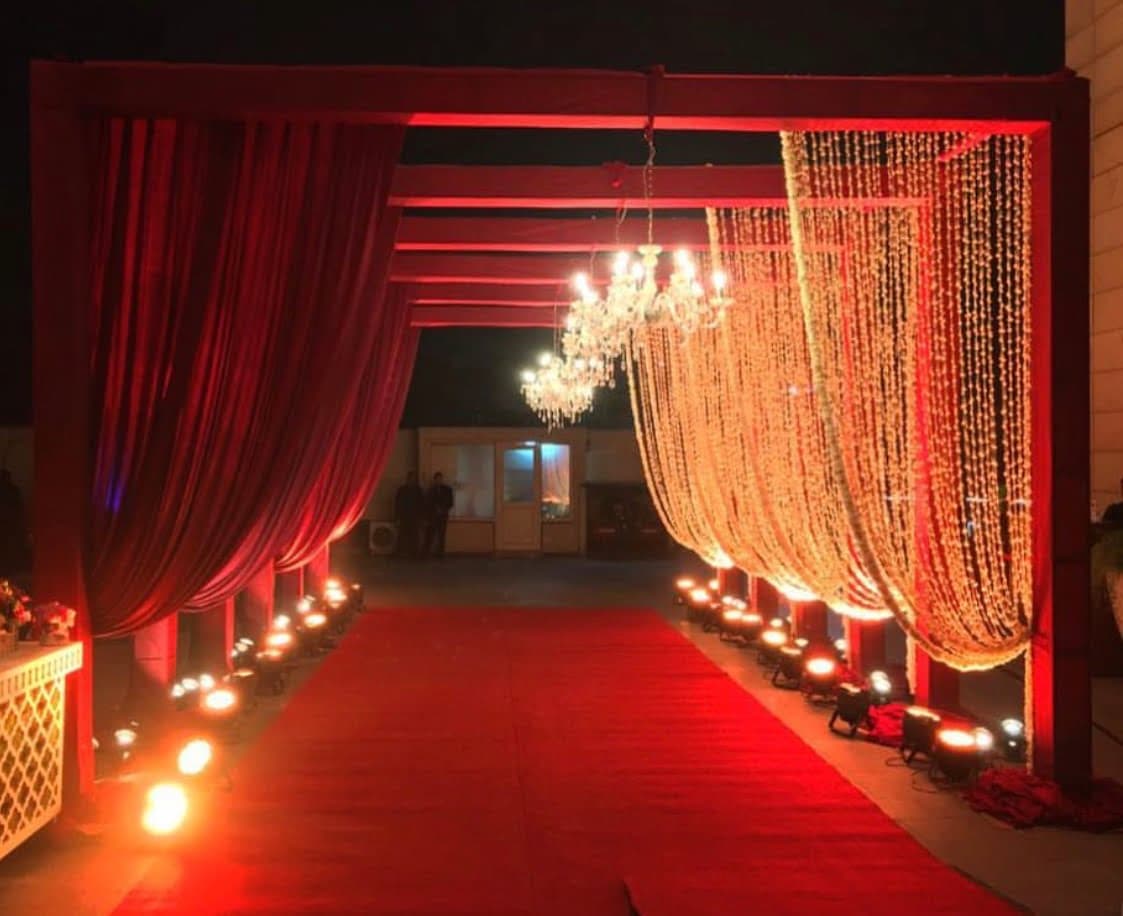 Red curtain wedding entrance with a chandelier